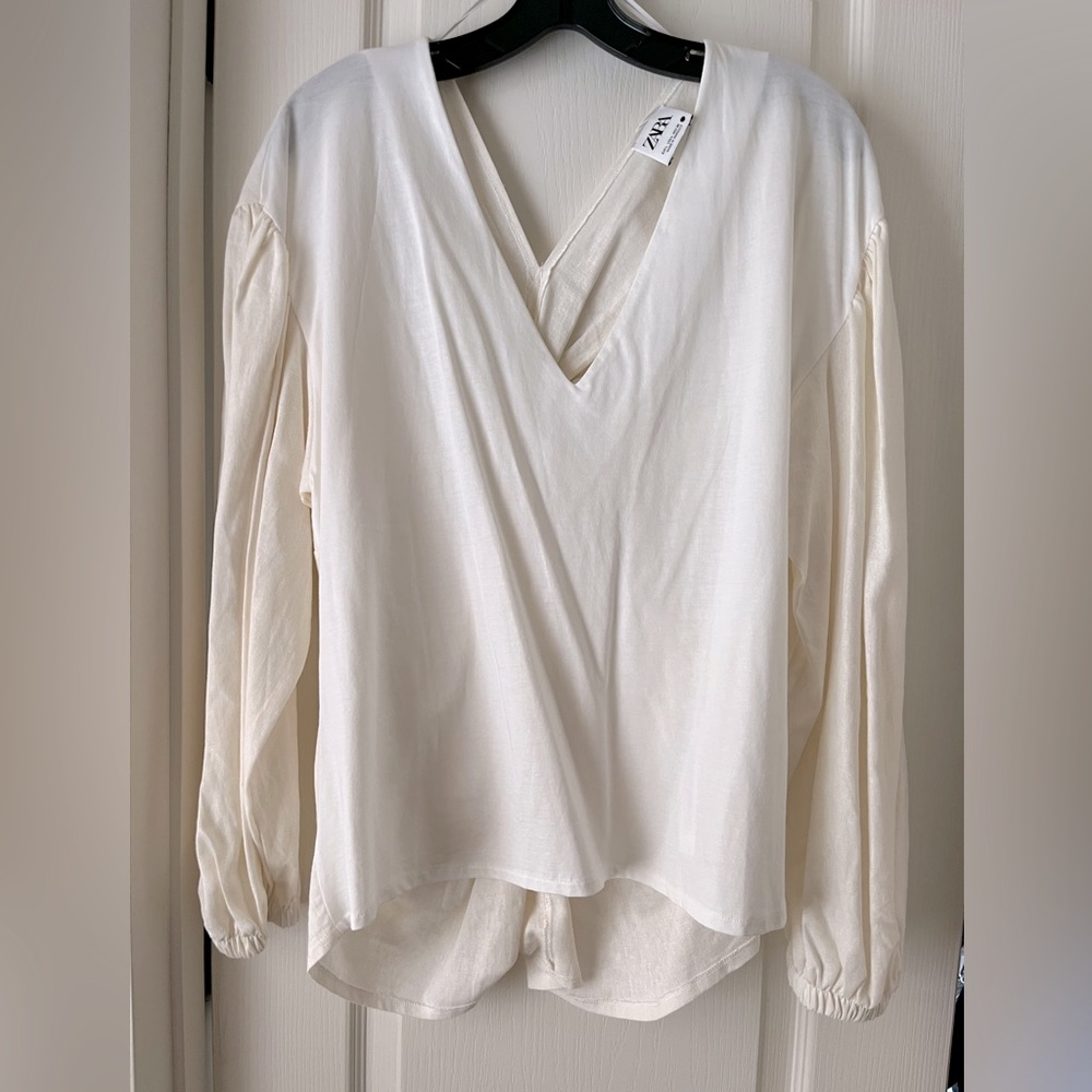Cream colored linen blouse.